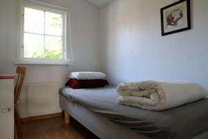a bed in a room with a window at Villa near Åhus in Yngsjö