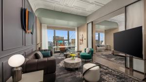a living room with a couch and a flat screen tv at Hotel Indigo Ningbo by IHG in Ningbo