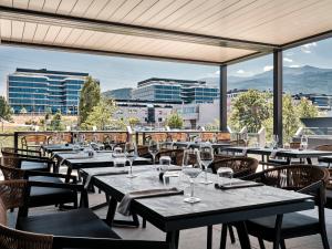 a row of tables with wine glasses on a patio at Crowne Plaza Sofia by IHG in Sofia