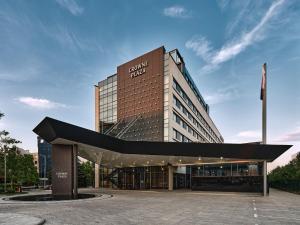 a building with a curved roof in front of it at Crowne Plaza Sofia by IHG in Sofia