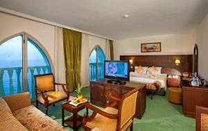 a hotel room with a bed and a television at Crowne Plaza Antalya by IHG in Antalya