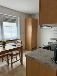 a kitchen with a table and a counter top at Ruhig gelegene Ferienwohnung in Waldbrunn +2 photos