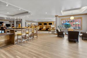 a lobby with chairs and a bar in a restaurant at Holiday Inn Dubuque/Galena by IHG in Dubuque