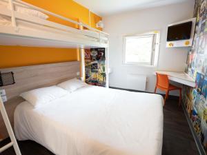 a bedroom with a white bed and a desk at hotelF1 Brive Ussac in Ussac