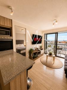 a kitchen and living room with a view at Deptos Estudios y de 2 dormitorios, Central, San Martin 2426. Sector Mall Plaza, Cowork y Factura. in Antofagasta