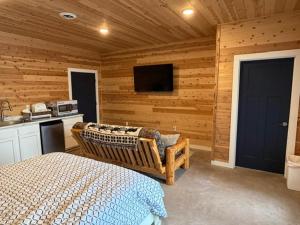 a bedroom with a bed and a tv in a room at Cedar Studios at Whitetail Estates in Babbitt