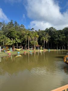 a water park with a playground and a pond at Pesqueiro Restaurante e Pousada Pingo de Ouro in Piedade +10 photos
