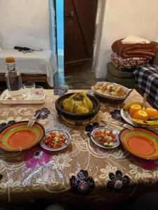 a table with plates of food on top of it at Gîte flilou in Midelt