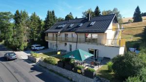 a house with solar panels on the roof at Horský penzion a bistro Čepice in Pernink