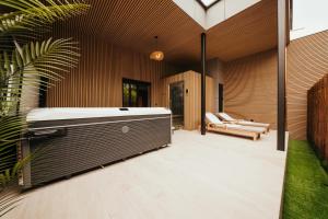 a hot tub on the side of a house at Hotel Casino Elite in Quiévrain