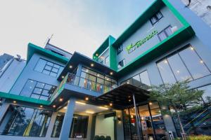 a building with a sign on the front of it at The Bedroom in Hat Yai