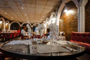 a table in a restaurant with glasses on it at Hotel Résidence La Falaise in Douala