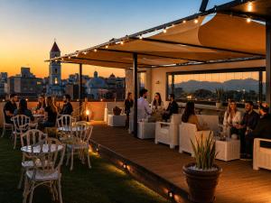 a group of people sitting on a deck at sunset at My exclusive cavour loft da sogno a cagliari in Cagliari