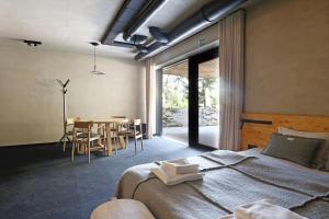 a bedroom with a bed and a table with chairs at Wilcza For Rest in Karpacz