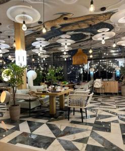 a restaurant with a lobby with a table and chairs at РАДУГА Иссык-Куль in Chon-Sary-Oy