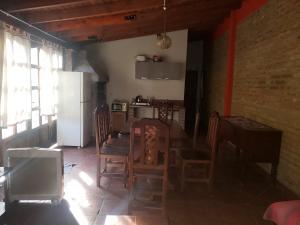 a kitchen with a table and chairs and a refrigerator at Posada Valentina in San Salvador de Jujuy