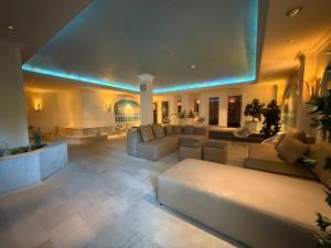 a large living room with couches and a large ceiling at revita - naturresort & spa in Bad Lauterberg