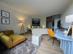 a bedroom with a bed and a table and chairs at revita - naturresort & spa in Bad Lauterberg