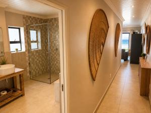a bathroom with a shower and a sink at White Sands Self-catering units in Wilderness +145 photos