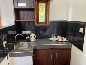 a kitchen with a sink and a counter top at Sea Tide by Jade Rock in Negombo +56 photos