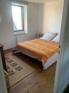 a bedroom with a bed and a window at Ti Bihan in Plouguerneau +5 photos