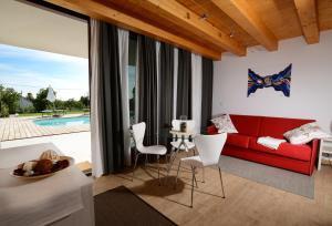 a living room with a red couch and a table at B&B Sgonico in Sgonico