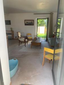 a living room with a couch and a table at Ti Bihan in Plouguerneau