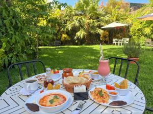 a table with food and drinks on it at Alana Hotel By ISH in Antigua Guatemala +25 photos