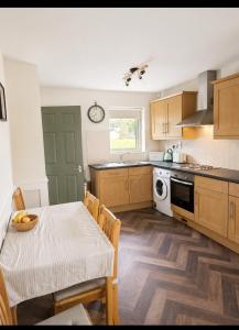 a kitchen with a table and a dining room at The Greenmount in Westport