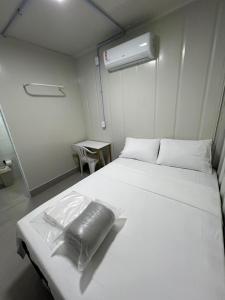 a large white bed in a small room at Urban Box in Sinop
