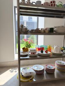a shelf with plates and dishes on it with a window at Namus House in Stepʼanavan