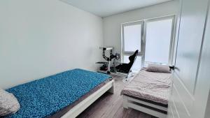 a bedroom with a bed and a treadmill and a window at Ungura Nord in Mozūriškiai +2 photos