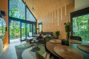 a woman sitting on a couch in a living room at Green House - why not in Kismaros