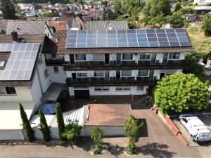 an aerial view of a house with solar panels on the roof at Hotel Es Lämmche in Breuberg