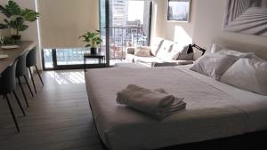 a bedroom with a bed with a towel on it at VIP Suite Antofagasta in Antofagasta
