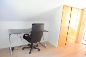 a desk and a chair in a room with a door at Beautiful apartment in Treuchtlingen