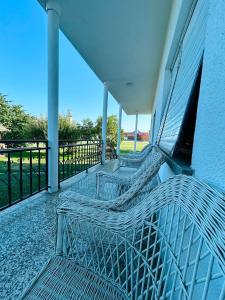 a balcony with two benches on a building at L&M Apartman in Virje +8 photos