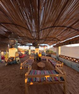 a room with chairs and a table and a roof at Nubian Kingdom Aragheed House in Aswan