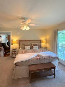 a bedroom with a bed and a ceiling fan at Large 6BR Home on White River, WiFi, Sleeps 12 in Eureka Springs