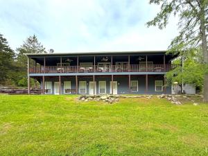 a large house with a lawn in front of it at Large 6BR Home on White River, WiFi, Sleeps 12 in Eureka Springs