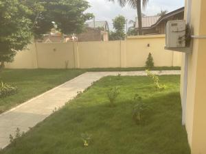 a yard with a fence and a sidewalk at The Vicarage in Lashibi