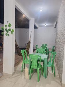 a group of green tables and chairs in a room at Casa de 3 Quartos px da Avenida dos Holandeses a 3km da Praia do Araçagy in São Luís +20 photos