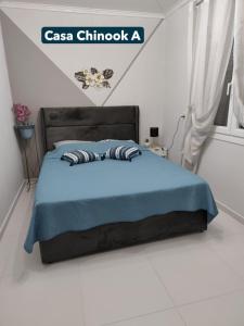 a bedroom with a bed with a blue comforter at Casa Chinook Sea View Homes-Porto Koufo in Porto Koufo +28 photos