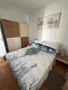 a bedroom with a large bed with blue pillows at Apartments Green Oasis in Vlašići