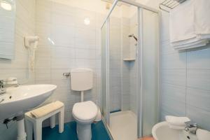 a bathroom with a toilet and a sink and a shower at Hotel Palladio in Caorle +55 photos