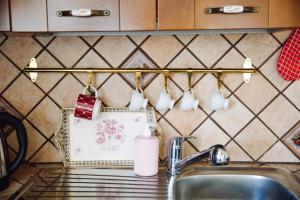a kitchen counter with a sink and a towel rack with cups at Raggio di sole in Catania +89 photos