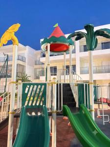a playground with a slide at Le Ramo - Résidence Ramoflores in Sidi Rahal