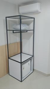 a glass shelf with a computer in a room at GoldMen Express Cianorte in Cianorte