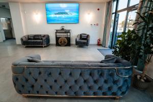 a living room with a couch and two chairs at Airport Hotel - Baia Mare - Maramures in Baia Mare
