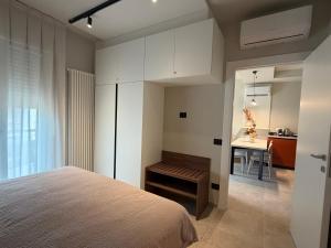 a bedroom with a bed and a table in a room at Dimora Nòva Verona in Verona